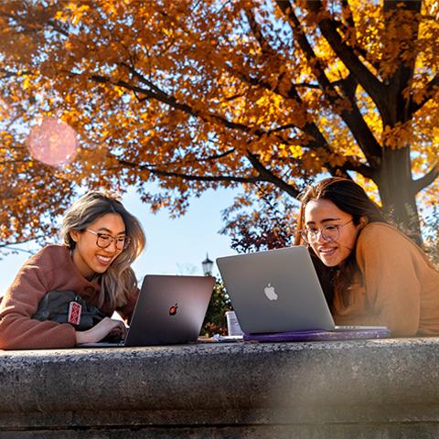 Students outdoors on laptops